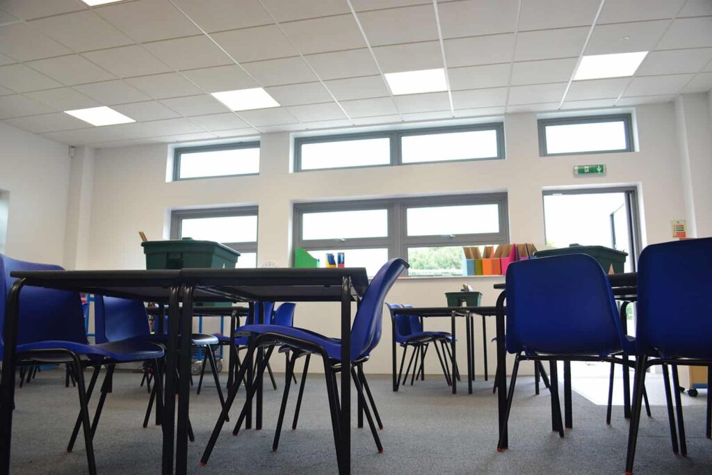 Childrens desks and chairs inside modular classroom. 